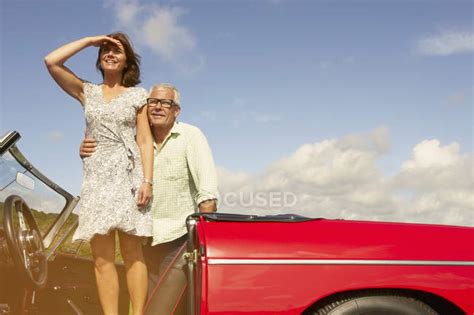 Senior Couple With Sports Car Observing — Copy Space Mature Couple