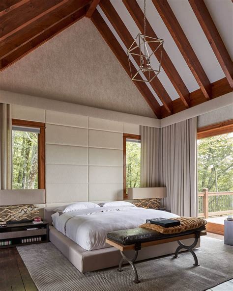 Luxurious primary bedroom featuring a beautiful bed set on the attractive carpet flooring. Vaulted Ceilings: A Modern Twist on Classic Architecture