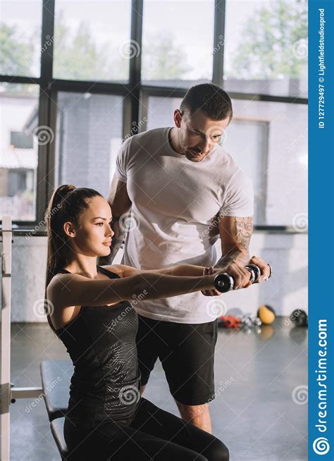 Male Personal Trainer Helping Sportswoman Stock Image Image Of Mature