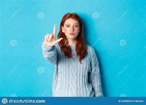 Serious Redhead Girl In Sweater Showing Taboo Gesture Extending One Finger Shaking Forefinger