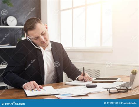 Broker Talking On Mobile Phone And Making Notes Stock Image Image Of