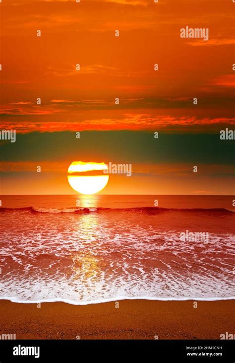 Epic Sunset Over Ocean Sea Waves And Sand Stock Photo Alamy