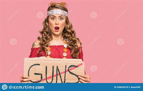 Young Blonde Girl Wearing Hippie Style Holding No Guns Warning Banner