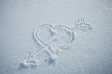 Heart With Arrow Drawn In Snow Love Symbol Painted On White Snowy