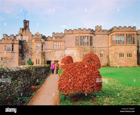 Two People Walk Through The Gardens At Haddon Hall Bakewell