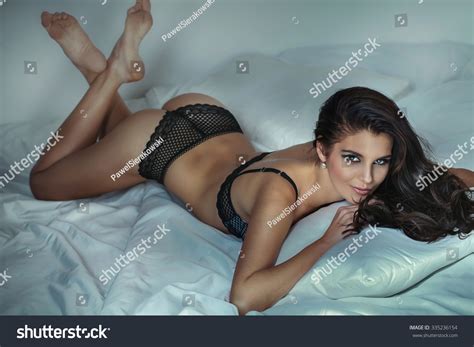 Sensual Beautiful Brunette Woman Posing In Lingerie Lying In Bed
