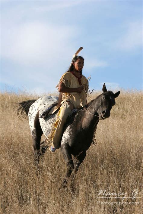 A Native American Man On Horseback Riding The Prairie Of South Dakota