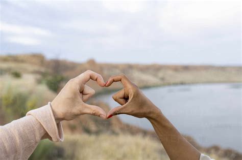 Couple Making Heart Shape With Hands Stock Photo