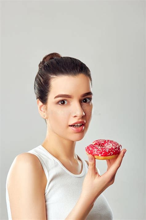 attractive brunette woman eating tasty donut dieting concept stock image image of eating