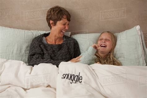 Mother And Daughter Laughing In Bed Stock Photo Dissolve