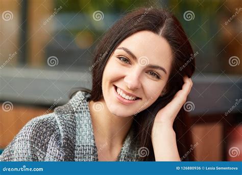 Close Up Shot Of Pleasant Looking Brunette Woman With Charming