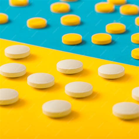 Free Photo | Scattered pills on yellow and blue background
