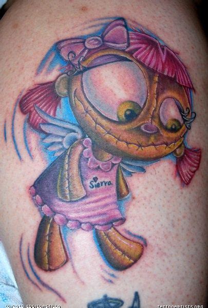 A Cartoon Character Tattoo On The Back Of A Womans Arm