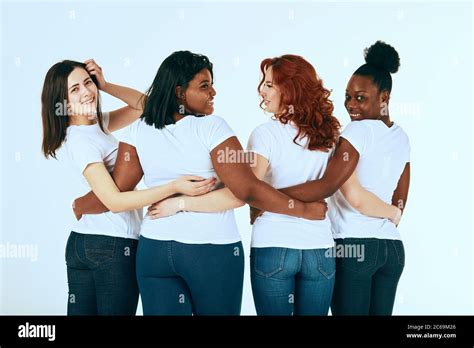 Back Side Of Multiracial Group Of Women Standing In Line In A Half Turn