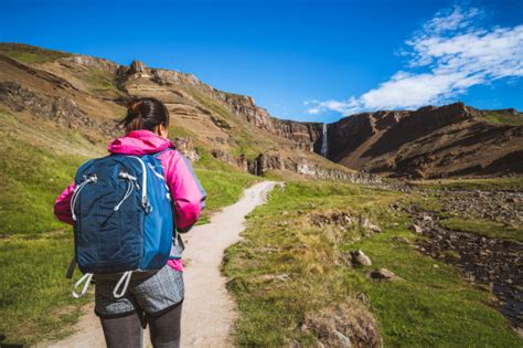 Premium Photo Traveler Hiking At Henoss Waterfall Iceland