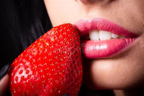 Portrait Of A Brunette Beauty With Honey Dripping Strawberry Stock