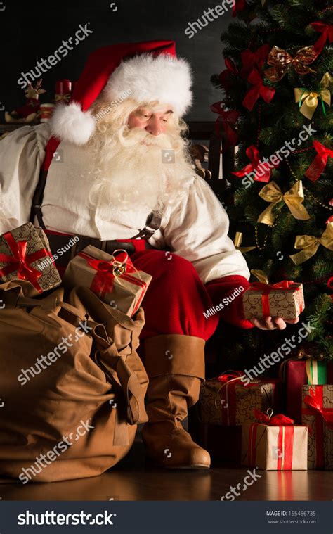 Santa Putting Gifts Under Christmas Tree Stock Photo Shutterstock