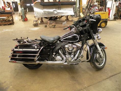 There is a set of fiberglass saddlebags,a rear rack behind the passenger seat and a blue diamond police tail light. 2012 Harley Davidson FLH Police SN#-1HD1FMM18CB691279