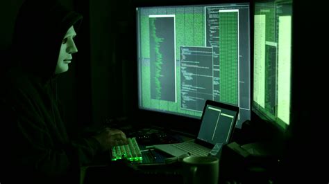 Side View Of Man In Mask And Hood Hacking Worldwide Network Using