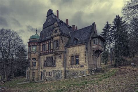 An Old Abandoned House In The Woods On A Cloudy Day
