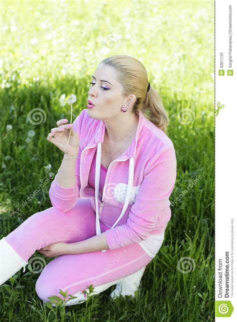 the beautiful girl in a pink suit blows on a dandelion stock image image of life human 53911121