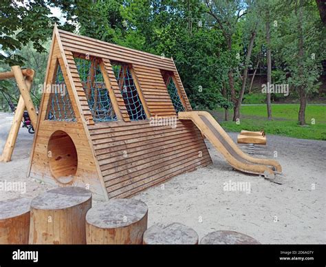 Childrens Playground Equipped With Wooden Swings And Slides A Modern