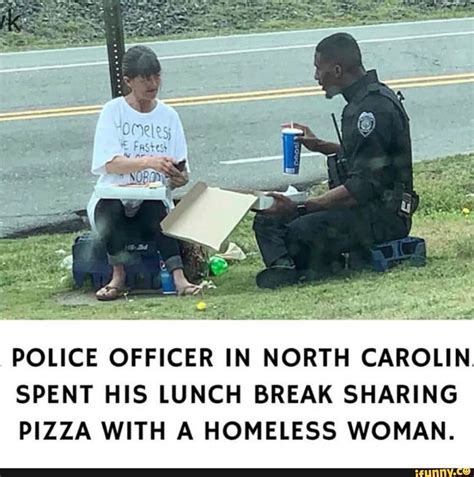 Two Police Officers Are Sitting On The Grass And One Is Eating Pizza With A Homeless Woman