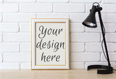 Download Gold decorated frame mockup with black table lamp By ...
