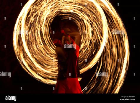 Firepoise Man Performance Artist Displaying Fire Patterns With Poi