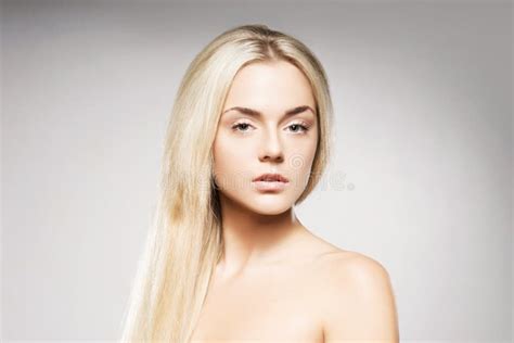 Blond Woman With Pure Skin Posing On Grey Background Stock Photo