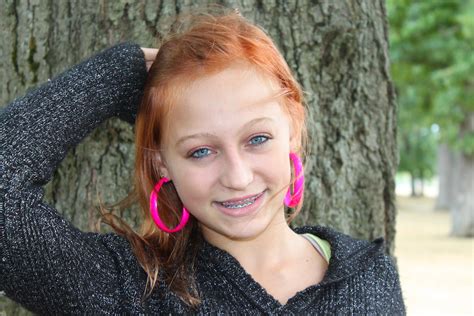 Female Teenager Teenager And Her Wild Pink Earrings