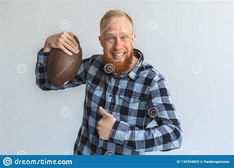 Freestyle Mature Man Standing Isolated On Grey With Ball Showing Thumb