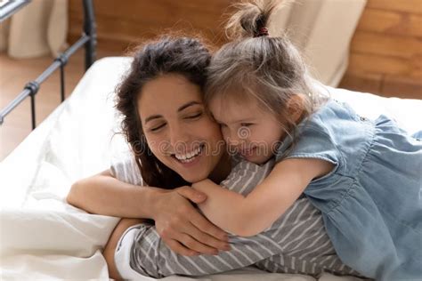 Close Up Smiling Mother And Little Daughter Cuddling In Bed Stock Image Image Of Indoor Lying