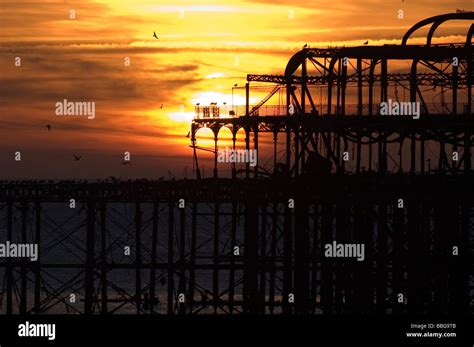 Sunset Over Brightons Derelict West Pier Stock Photo Alamy