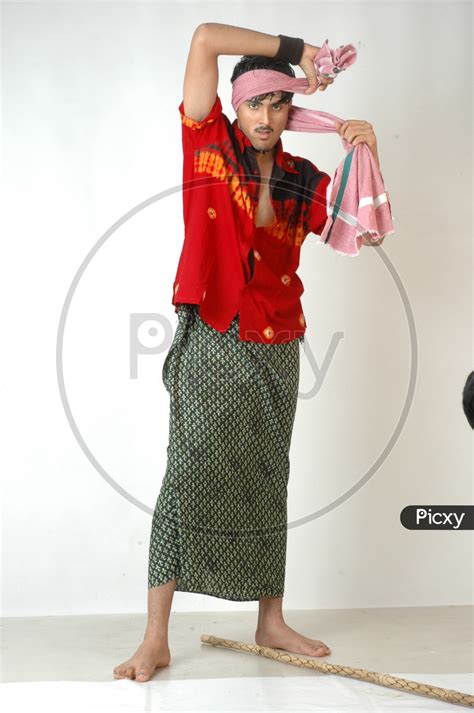 Image Of An Indian Man In Traditional Rural Man Attire Wearing Lungi And Gamcha Or Towel On Head