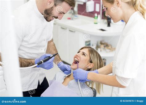 Young Woman Getting Dental Treatment In Dentist Office Stock Photo