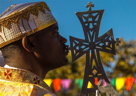 Ethiopian Orthodox Priest With A Cross Celebrating The Colorful Timkat