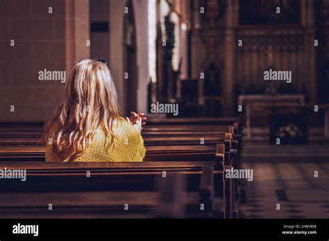 Young Woman Praying And Meditating In Church Belief In Jesus Christ