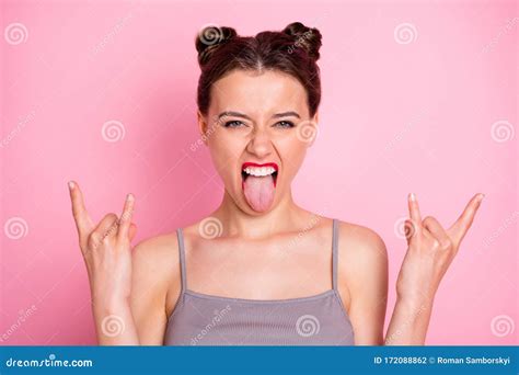 Photo Of Amazing Young Lady Funny Buns Red Pomade Showing Finger Horns Sticking Tongue Out Mouth