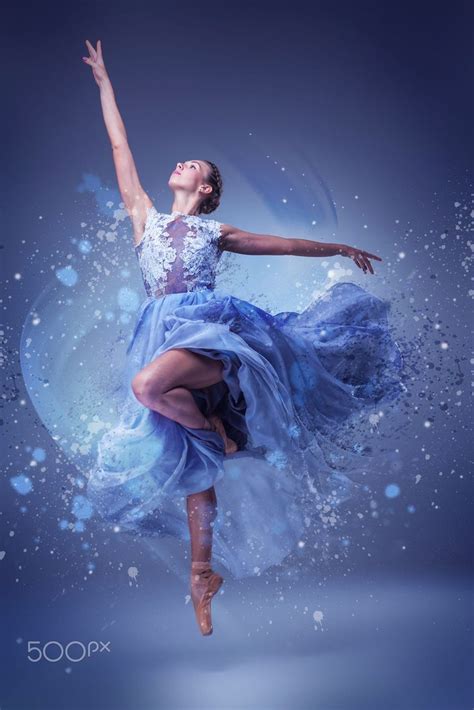 the beautiful ballerina dancing in long blue dress on blue background dancer photography