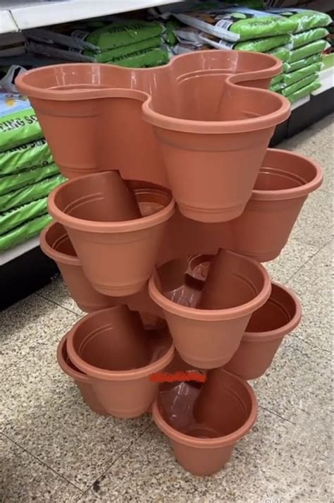 A Stack Of Clay Pots Sitting On Top Of A Store Floor