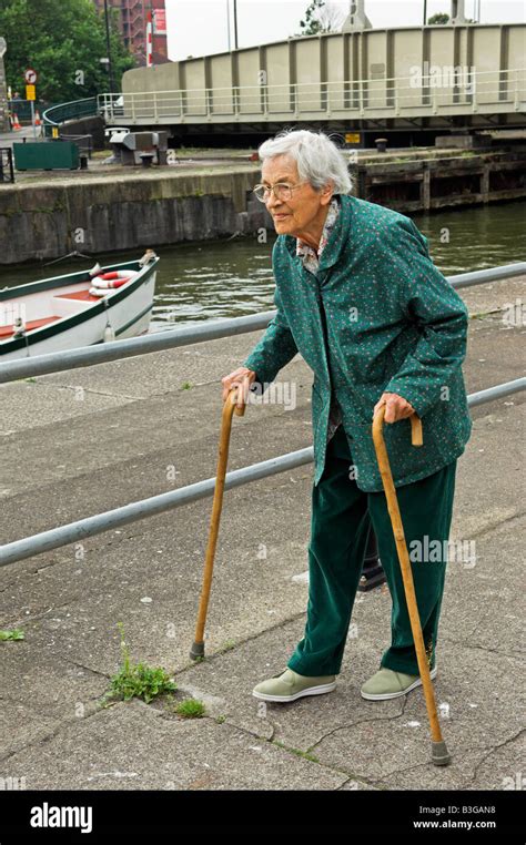 Active Elderly English 92 Year Old Woman Walking With Two Canes By