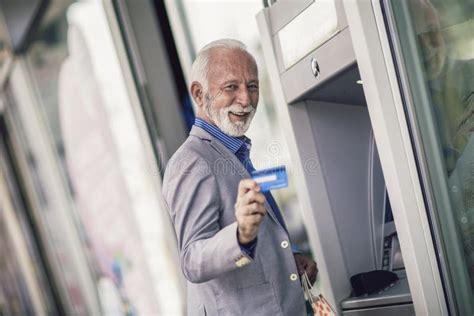Senior Man Using Atm Machine With Credit Card Stock Image Image Of