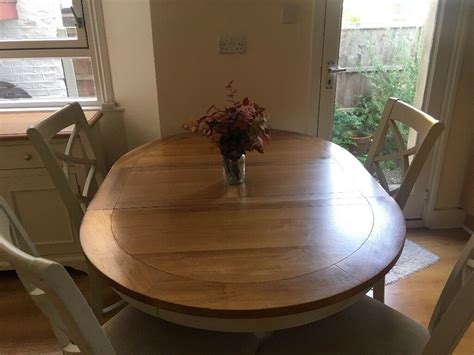 Extendable white round dining table and chairs. Solid Oak Top Round Extendable Dining Table and Chairs ...
