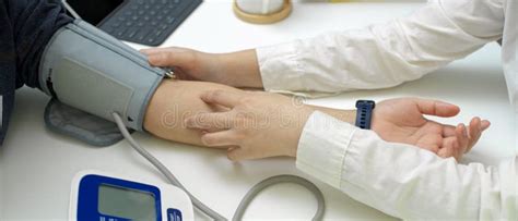 Doctor Medical Checkup Her Patient With Blood Pressure Monitor In