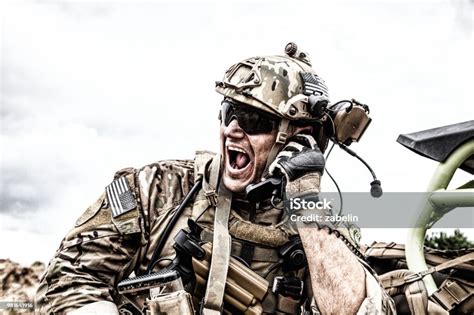 Soldier Communicating With Command During Battle Stock Photo Download