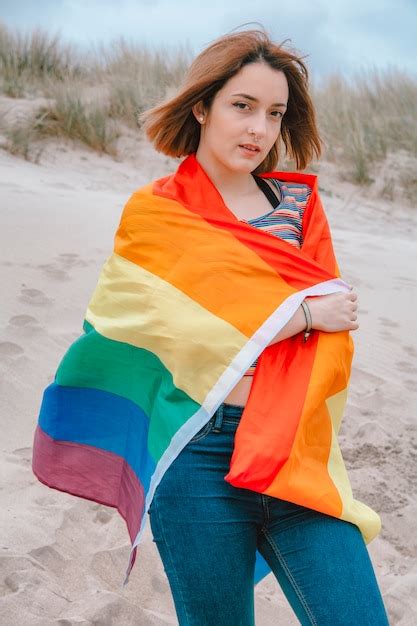 premium photo caucasian woman lesbian on the beach holding rainbow