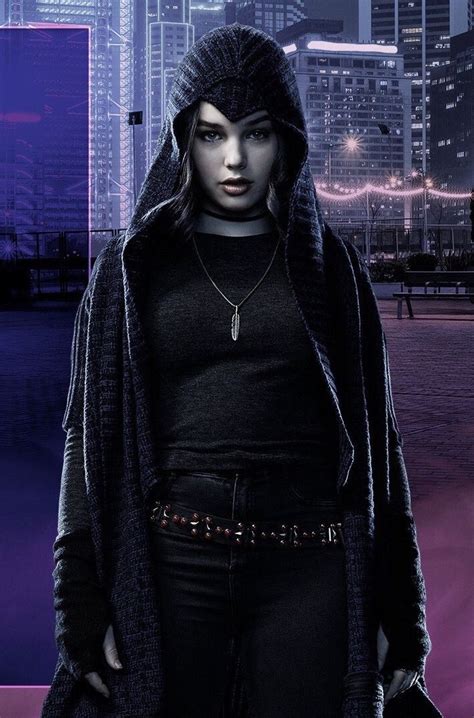 A Woman Standing In Front Of A Cityscape Wearing A Hoodie And Black Pants