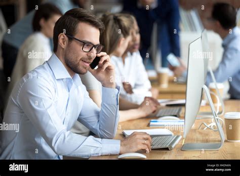 Confident Employee Talking By Phone With Client Customer Stock Photo