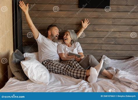 Mature Couple At Home In The Morning Feeling Excited Stock Image